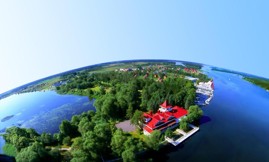 a large house on an island in the water at Recreational resort Zavidovo in Zavidovo