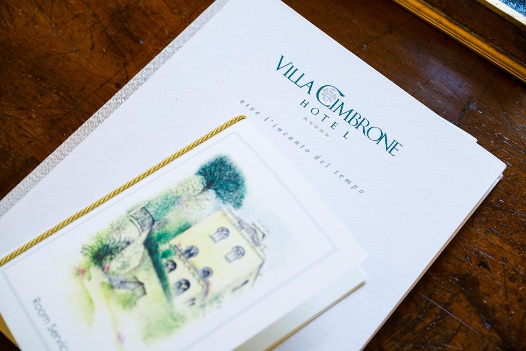 a book with a picture of a house on it at Hotel Villa Cimbrone in Ravello