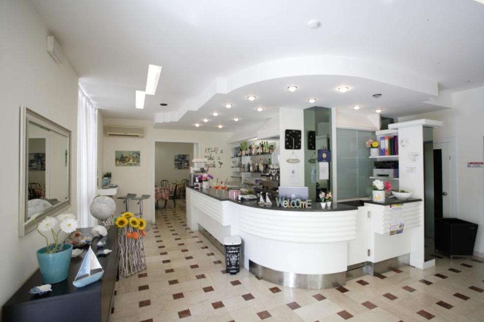 a large room with a counter in a store at Hotel Tosi in Riccione