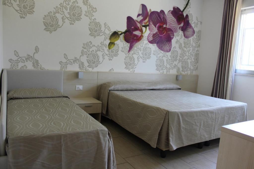 Postel nebo postele na pokoji v ubytování Hotel Alex