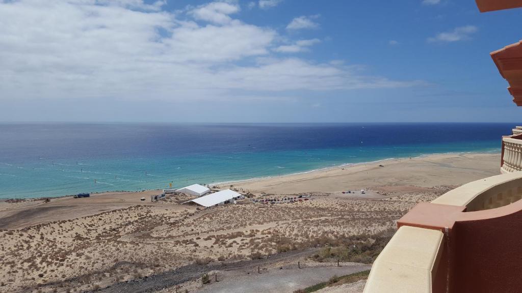 a view of a beach and the ocean from a building at THE PARADISE ON THE OCEAN 10 in Costa Calma