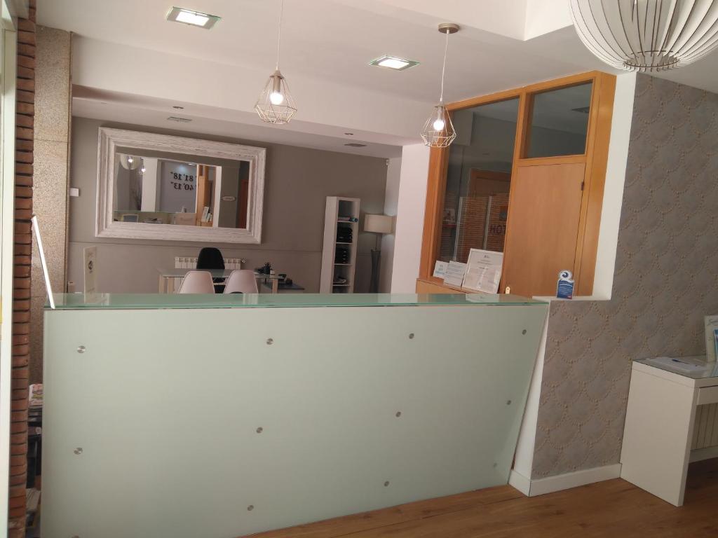 a kitchen with a white counter top in a room at Hotel Marycielo in Sanxenxo