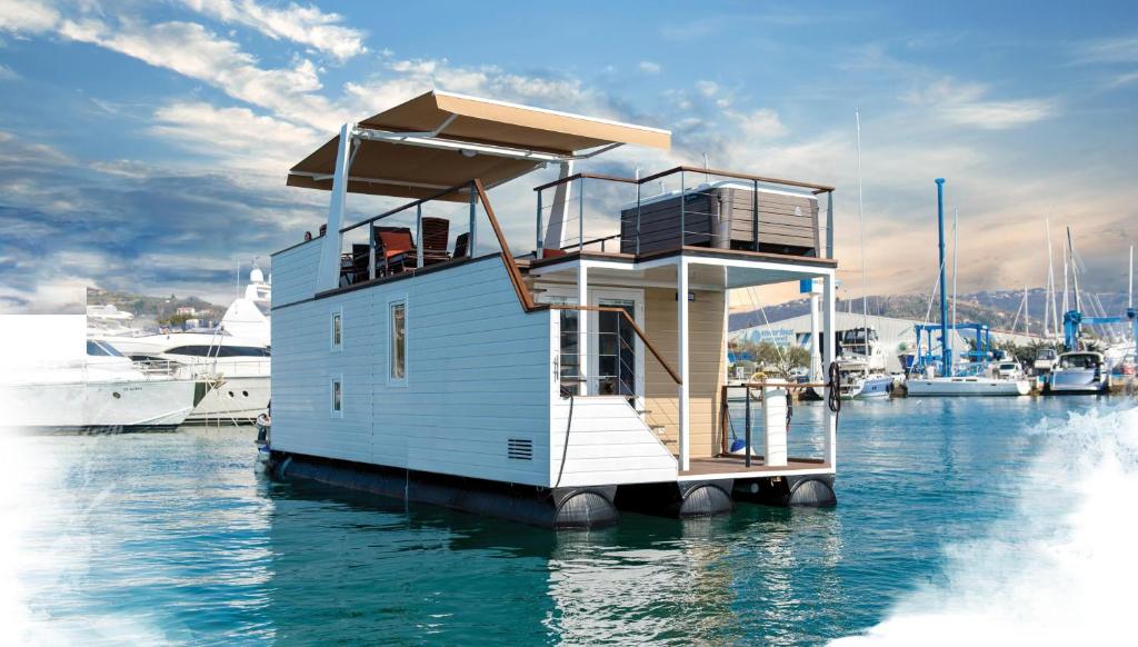 a small house on a dock in the water at Floating House Adela in Portorož