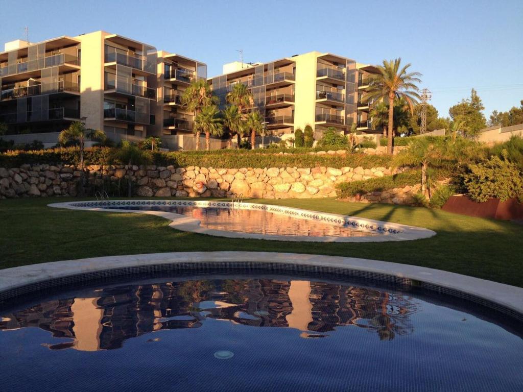 a swimming pool in front of a apartment building at Paradise Village in Salou