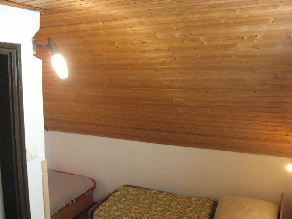 Cette chambre est dotée d'un mur lambrissé et d'un lit. dans l'établissement Zrinyi u. 16., à Vonyarcvashegy