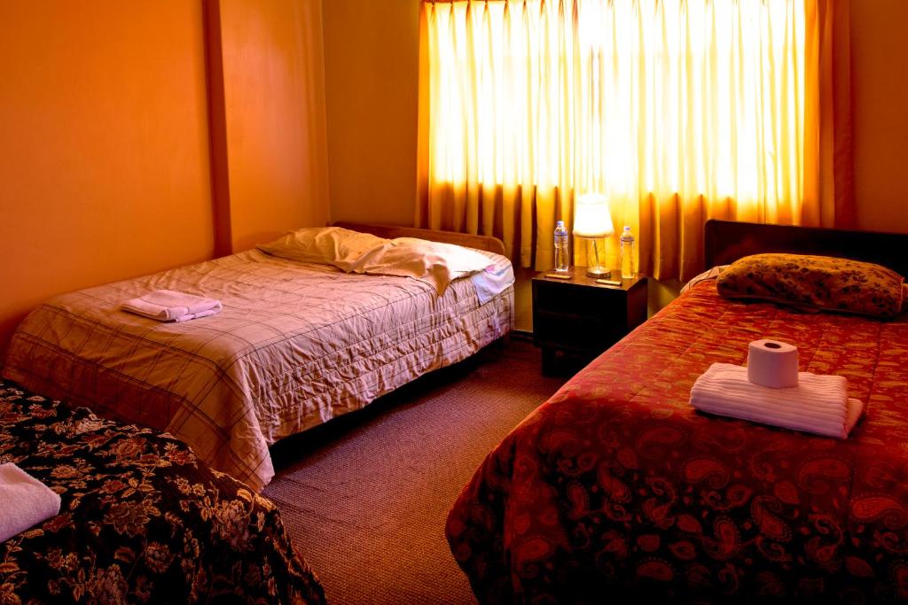 Postel nebo postele na pokoji v ubytování Hostal Virgen de Las Nieves II