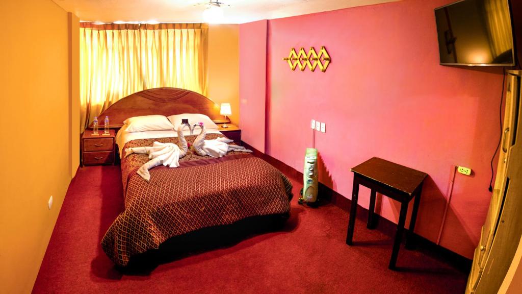 Postel nebo postele na pokoji v ubytování Hostal Virgen de Las Nieves II
