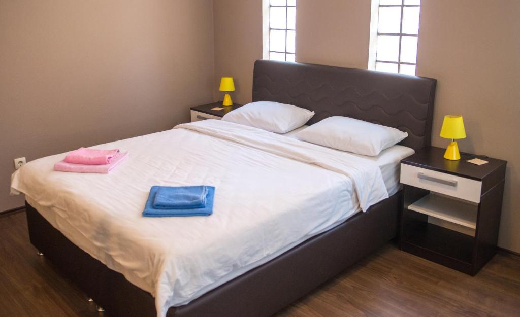 a bedroom with a bed with two towels on it at Guesthouse Stari Grad in Mostar