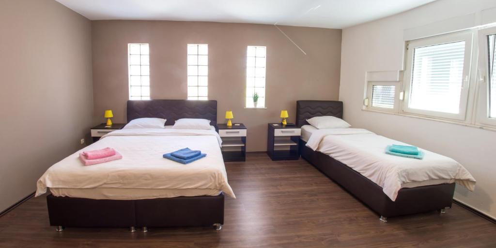 a bedroom with two beds with towels on them at Guesthouse Stari Grad in Mostar