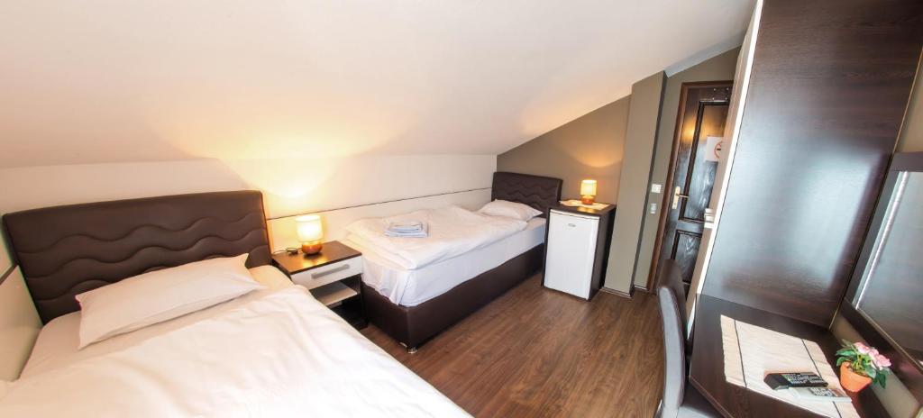 a small room with two beds and two lamps at Guesthouse Stari Grad in Mostar