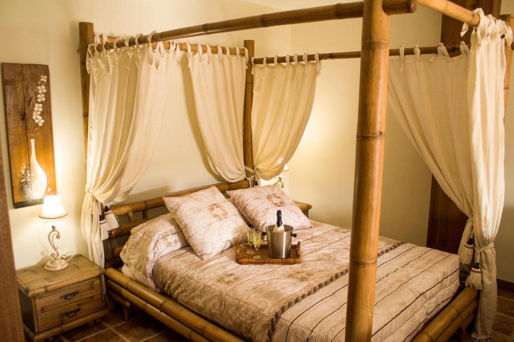 a bedroom with a canopy bed with a table on it at Alojamientos Victoria in Sigüenza