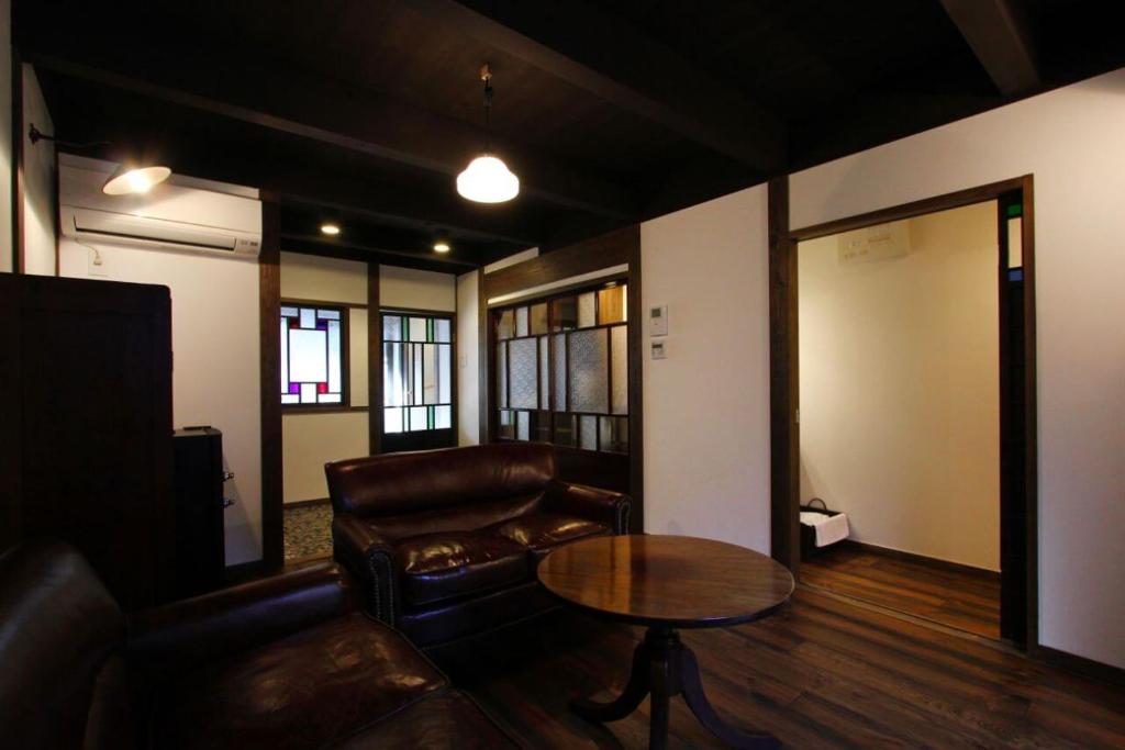 a living room with a couch and a table at Azuki an Machiya House in Kyoto