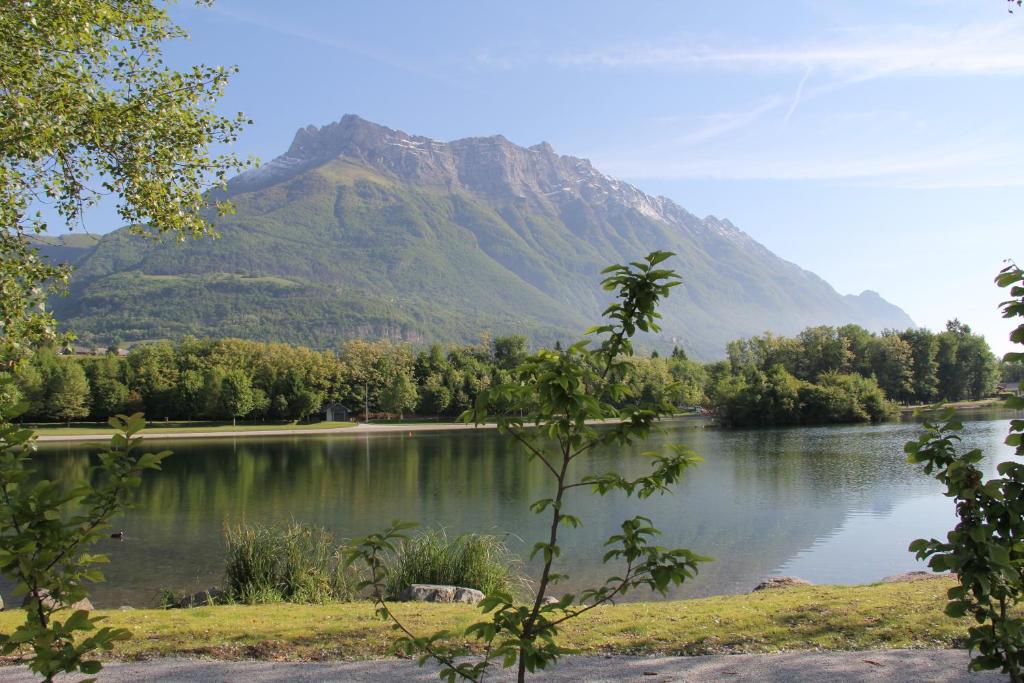a mountain sitting next to a lake with a mountain at juste pour le plaisir in Saint-Pierre-dʼAlbigny