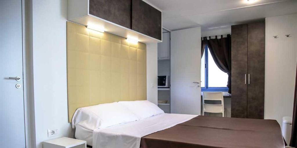 Postel nebo postele na pokoji v ubytování Camping villaggio L'Ultima spiaggia