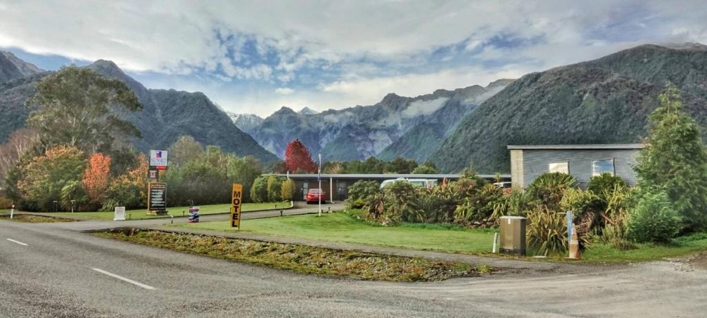 a road that has some trees on it at Sunset Motel in Fox Glacier