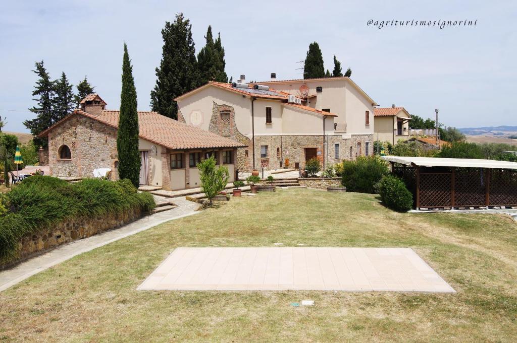 a large house with a large yard in front of it at Agriturismo Signorini in Orciatico