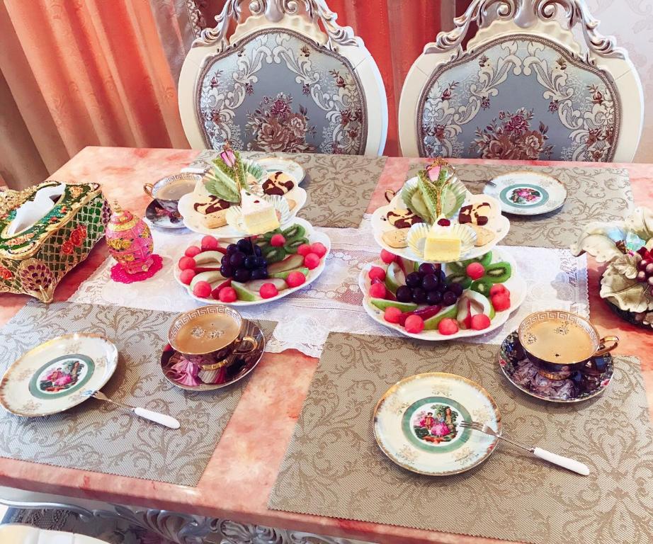 a table with plates and bowls of food on it at Sophia B&amp;B in Dongshan