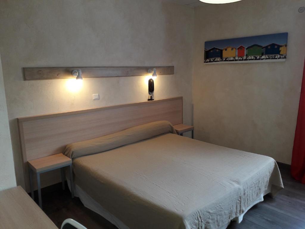 Postel nebo postele na pokoji v ubytování Hotel Le Terminus