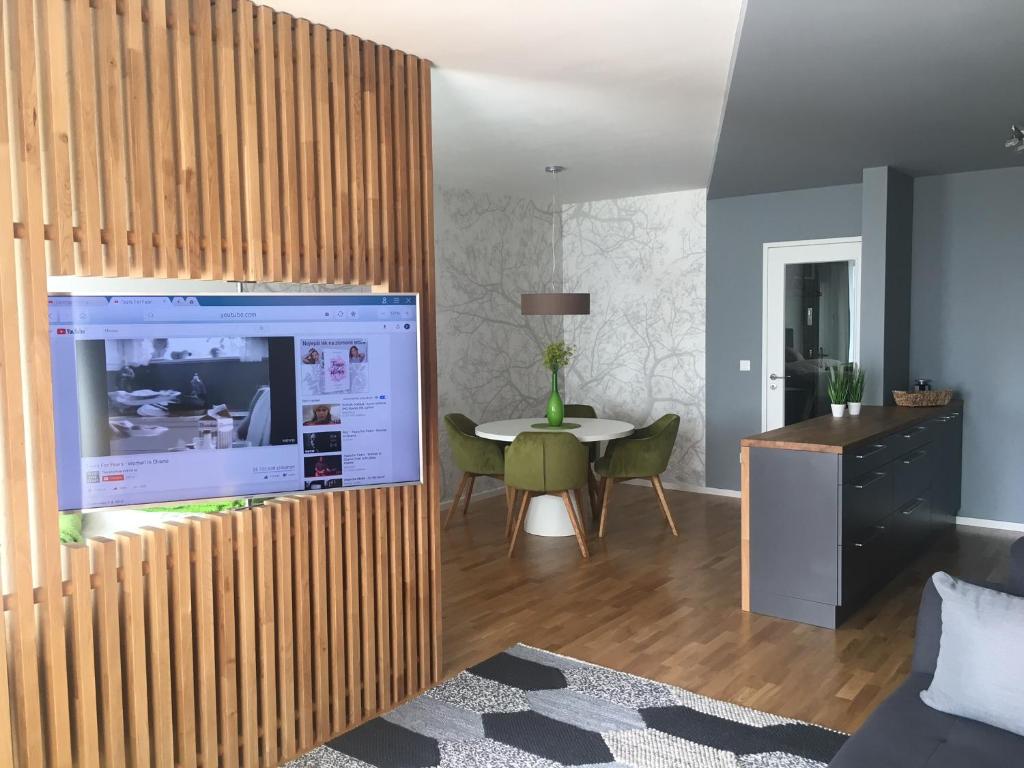 a living room with a large tv and a table at Apartment DOWNTOWN in Brno
