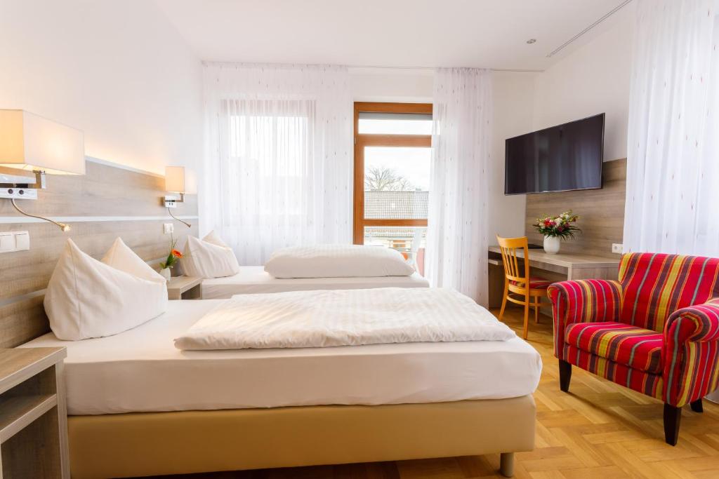 Postel nebo postele na pokoji v ubytování Hotel Spitzenpfeil