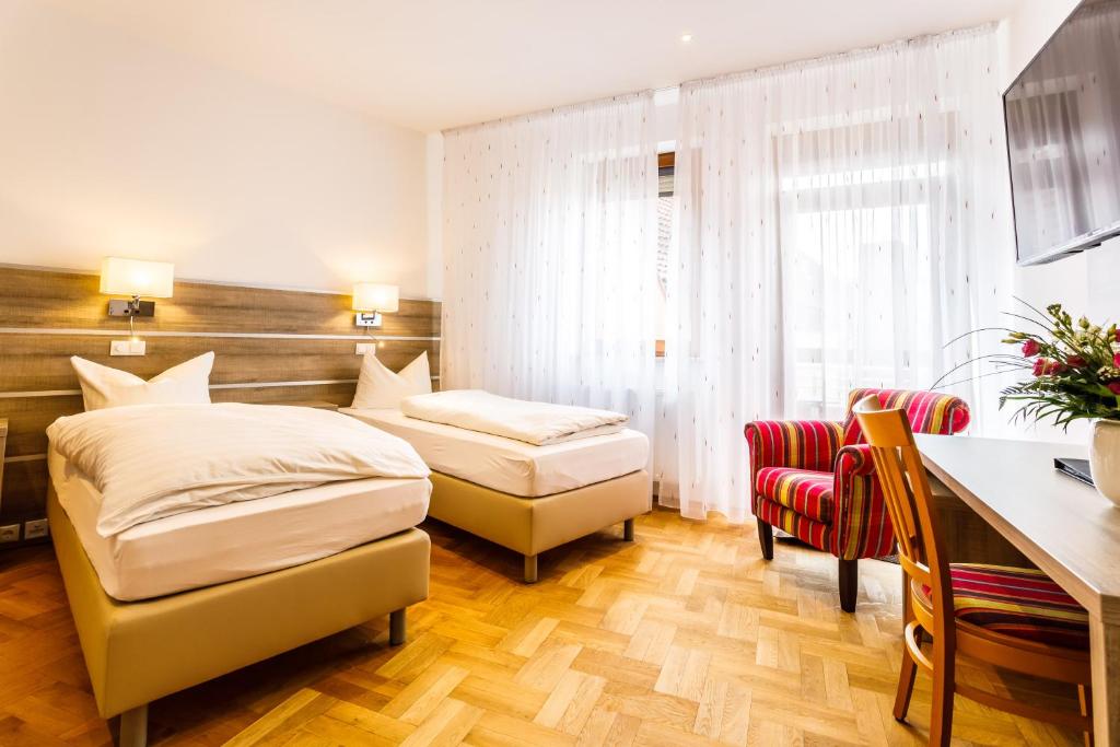 Postel nebo postele na pokoji v ubytování Hotel Spitzenpfeil