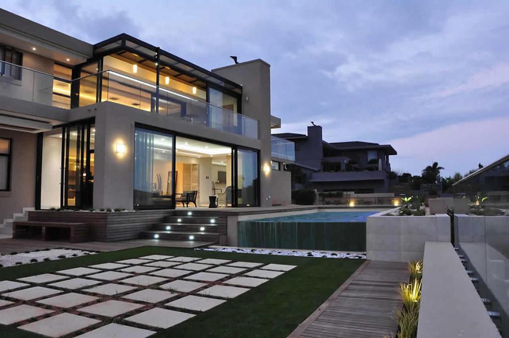 a large house with a swimming pool in front of it at Luxe Life House in Durban