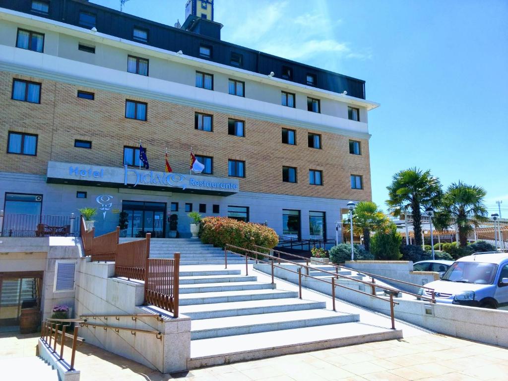 a large building with stairs in front of it at Hotel Hidalgo in Esquivias