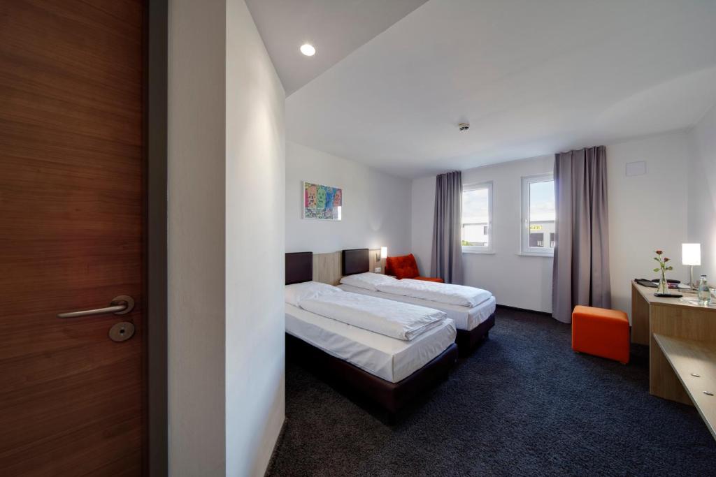 Postel nebo postele na pokoji v ubytování Euro Hotel Friedberg