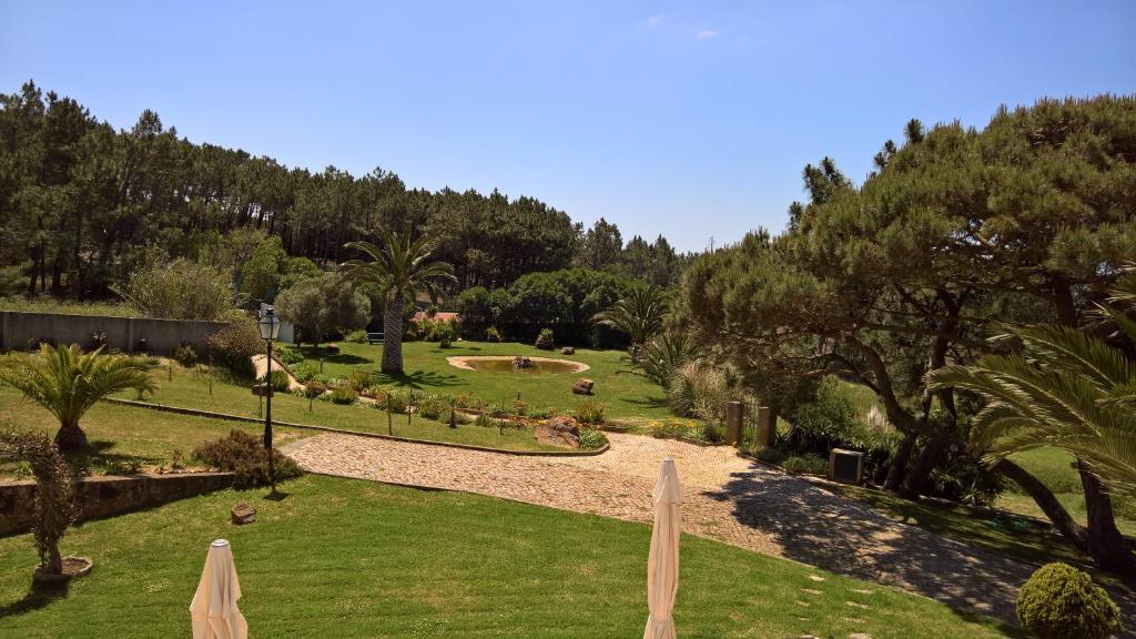 a view of a park with trees and grass at Quinta do Cabo Guesthouse in Sintra