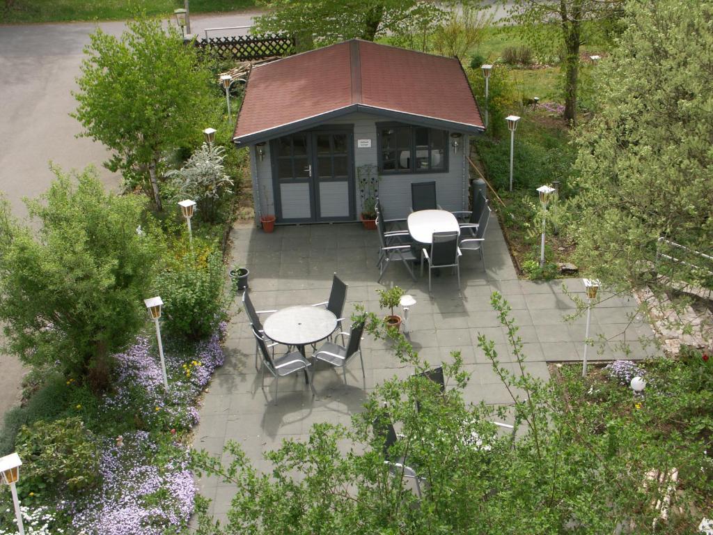 an overhead view of a garden with a table and chairs at Waldpension zum Felsenkeller in Lichtenfels-Sachsenberg