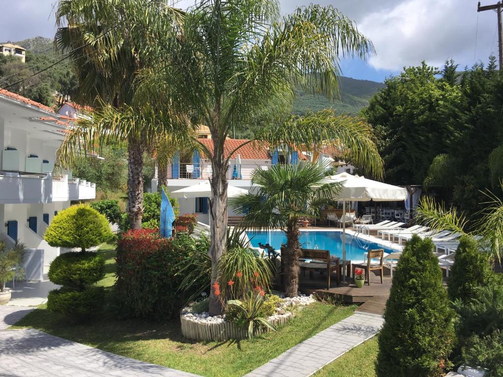 an aerial view of a resort with a pool and palm trees at Lemon Tree Hotel in Parga