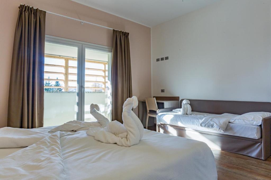 Postel nebo postele na pokoji v ubytování Hotel Milano