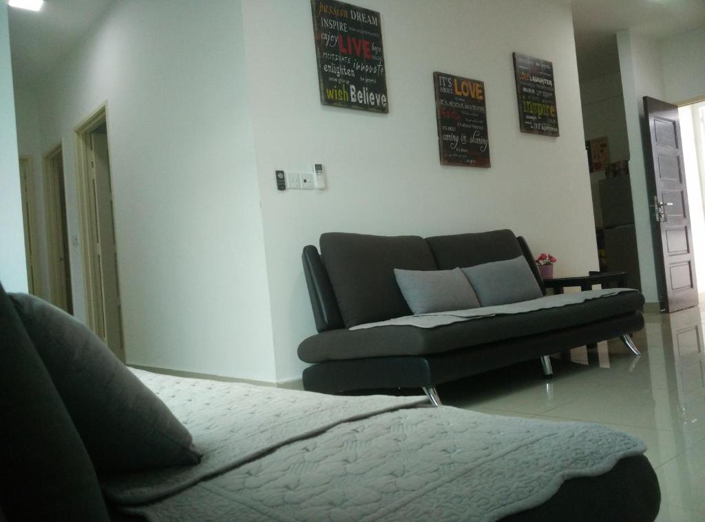 a living room with a couch and a chair at Apartel opp Spice Arena in Bayan Lepas