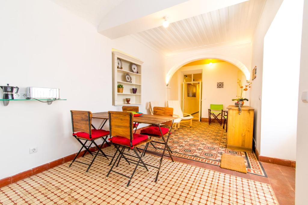 a dining room with a table and chairs at Casa Adelina By Algartur in Tavira