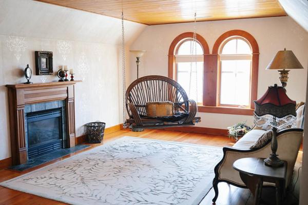 a living room with a fireplace and a couch at Round Barn Farm B & B Event Center in Red Wing