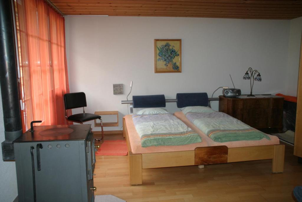 a bedroom with a bed and a table and a window at Bergdohle in Adelboden