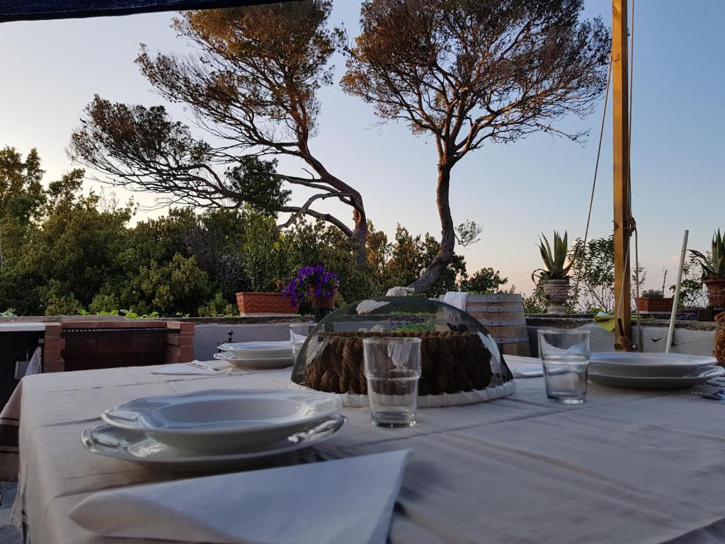 a table with plates and glasses on top of it at Villa Eugenia in Livorno