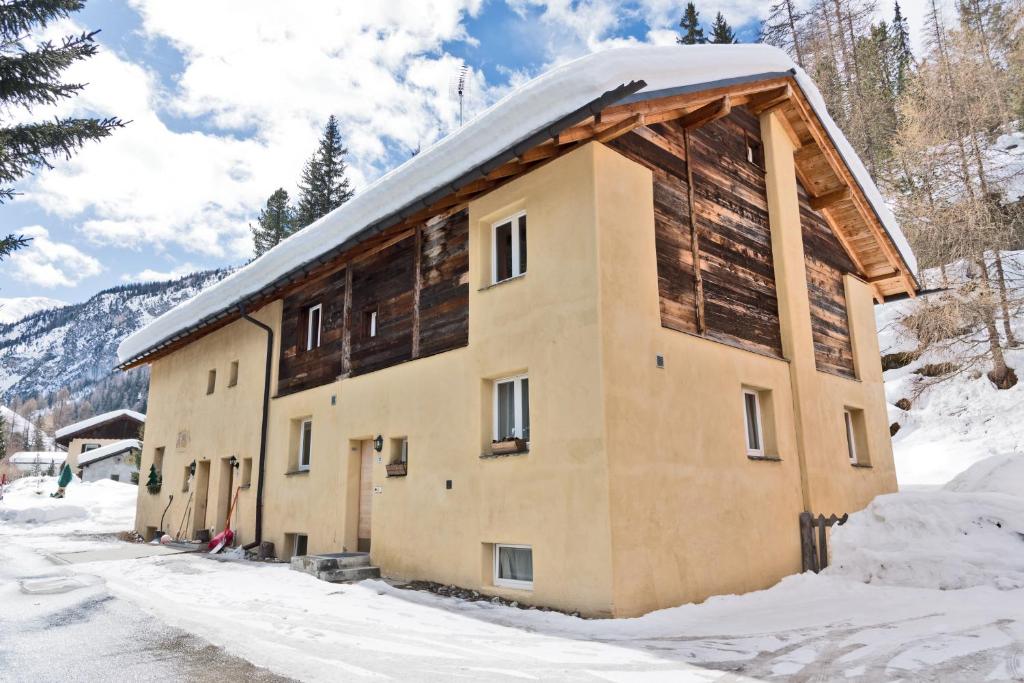 a building in the snow with snow at Chesa Gulas - La Punt-Chamues-ch in La Punt-Chamues-ch