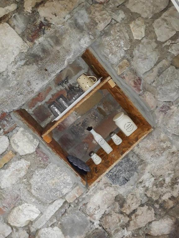 an overhead view of a box of bottles on a stone floor at Vicky Apartments in Kotor