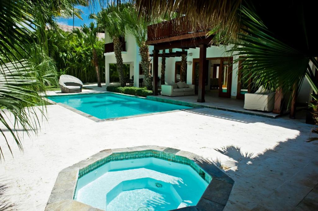 a swimming pool in front of a house at Beach&Golf Villa Bonita Punta Cana in Punta Cana