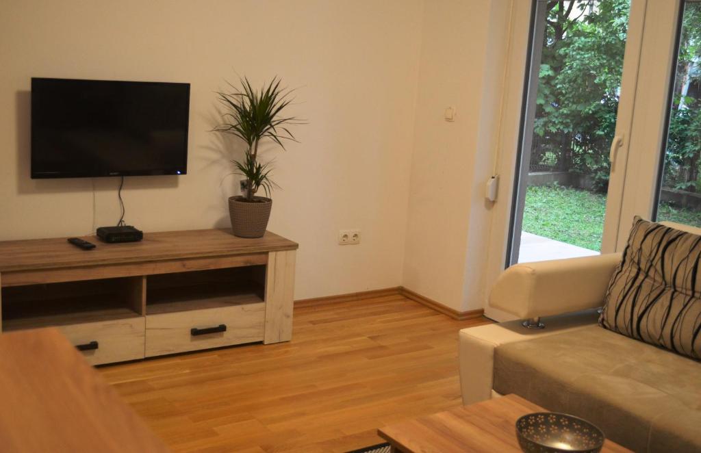 a living room with a couch and a flat screen tv at Apartment Abia in Bihać