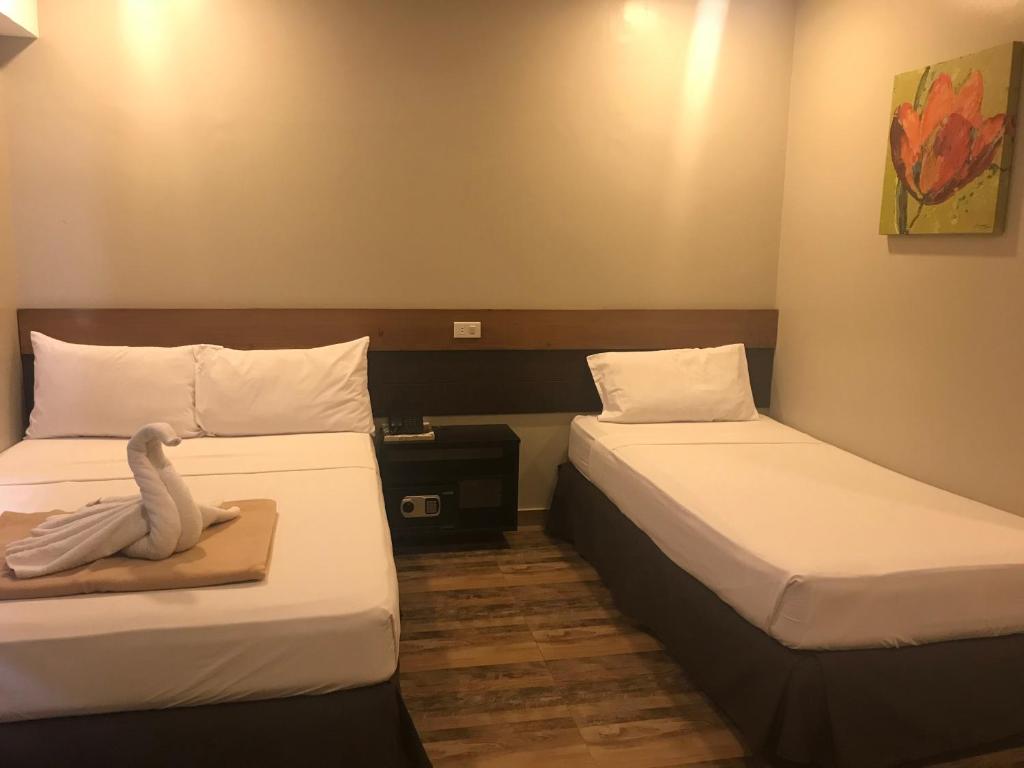 Postel nebo postele na pokoji v ubytování Cebu R Hotel Capitol