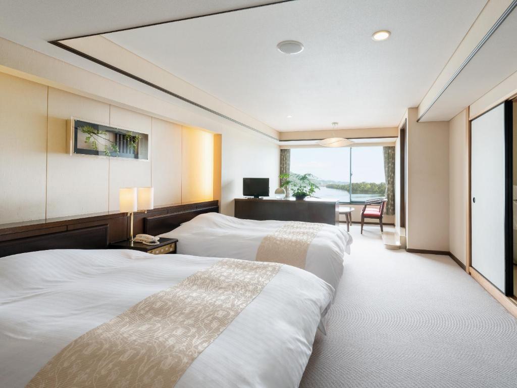 Voodi või voodid majutusasutuse Amano Hashidate Hotel toas