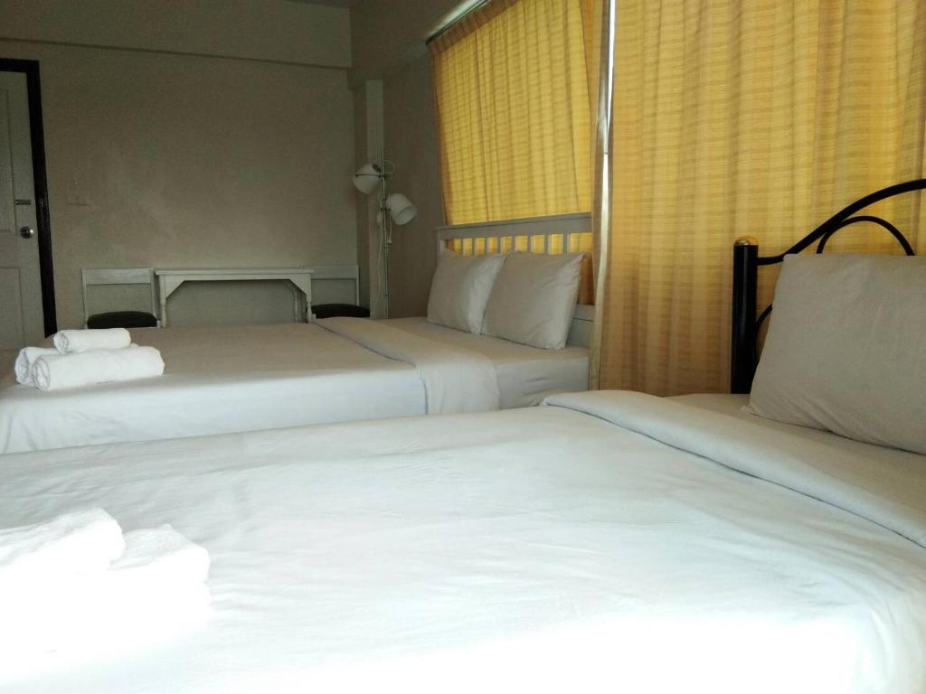 Postel nebo postele na pokoji v ubytování Lomsabai Apartments