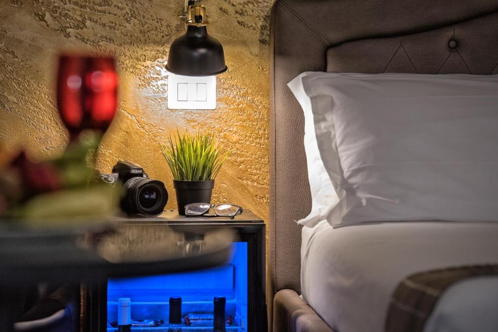 a bedroom with a bed and a table with a camera at Navona Jacuzzi Rooms in Rome