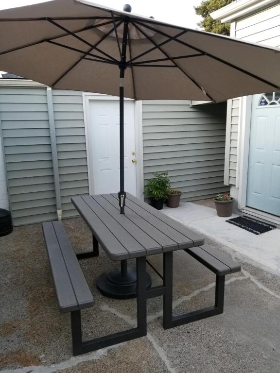 a picnic table with an umbrella and a bench at Duplex in Alberta Art District in Portland
