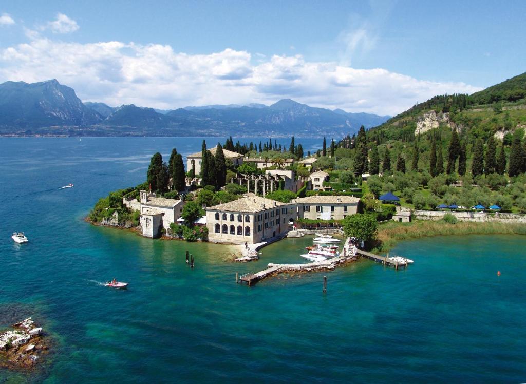 an island in the middle of a large body of water at Locanda San Vigilio in Garda