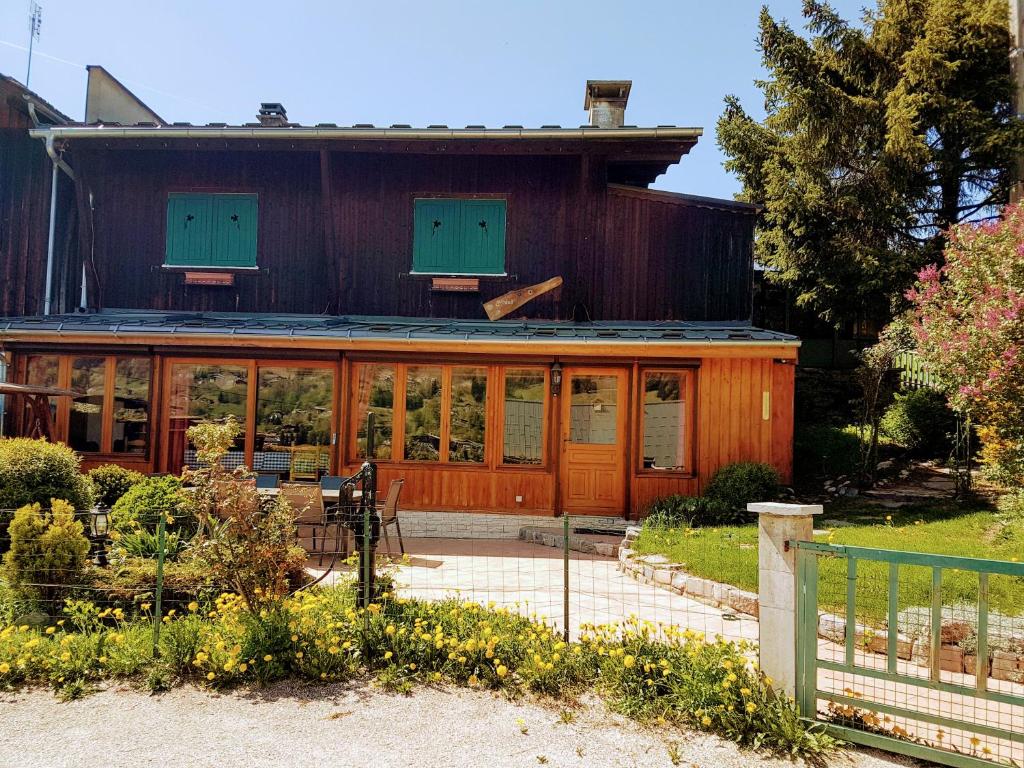 a wooden house with a lot of windows at Chalet Quatre Saisons in Saint-Gervais-les-Bains