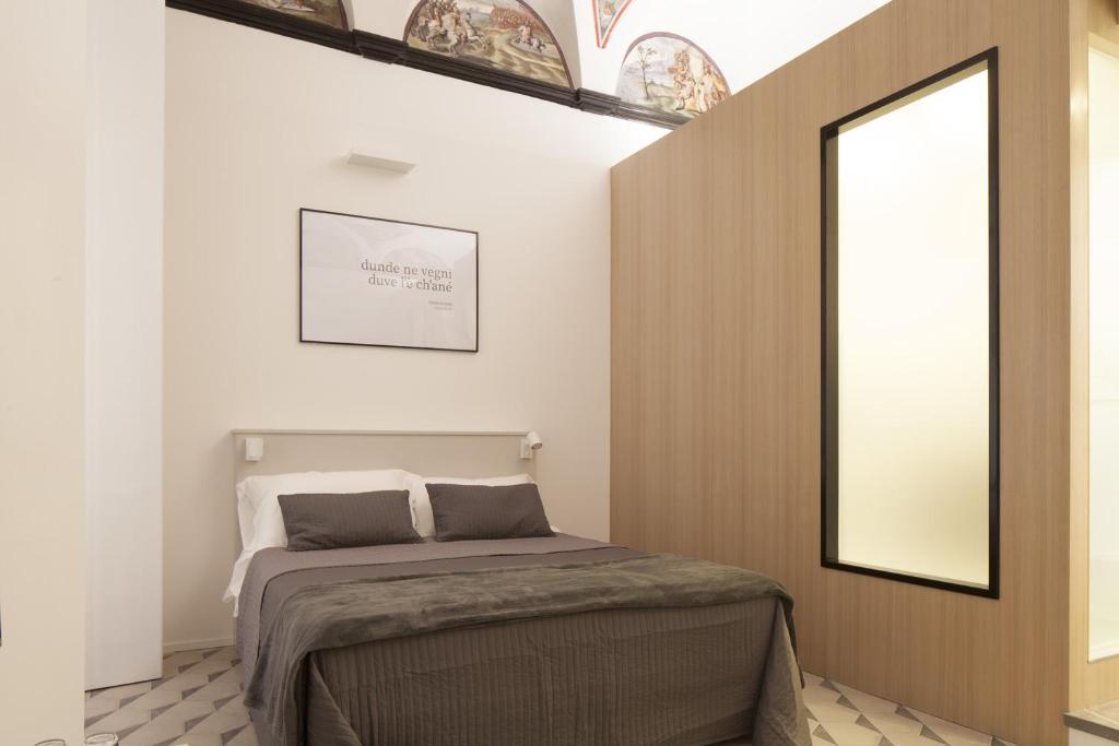 Postel nebo postele na pokoji v ubytování Genova Suite Art
