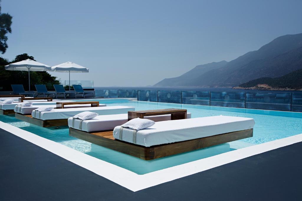 a swimming pool with several mattresses on top of a building at Alley Prime Hotel in Kaş